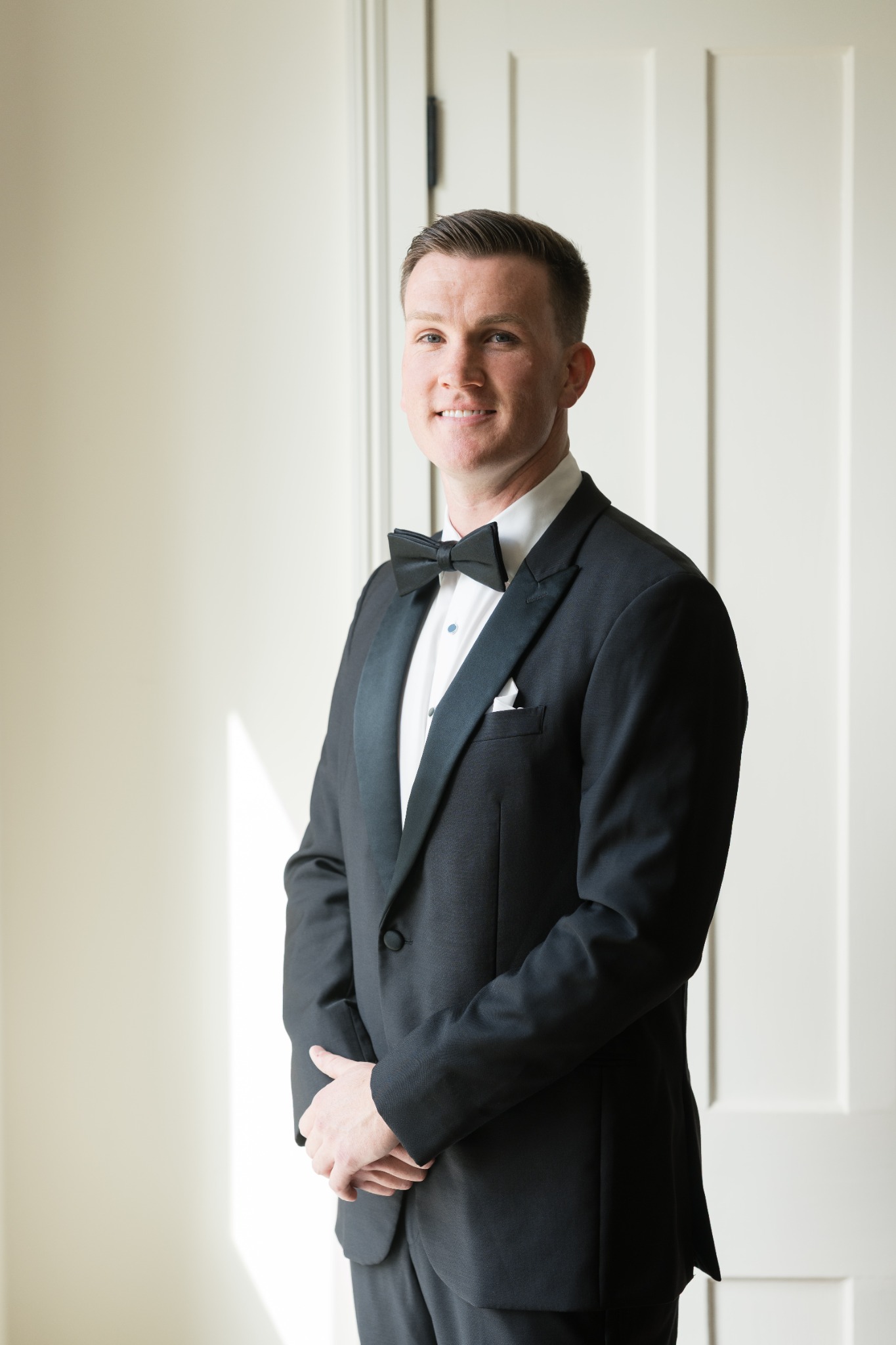 Sean in black tuxedo in soft natural light